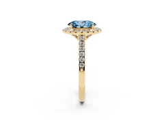 Fancy Blue Oval Cut Diamond Pavé Halo Engagement Ring Set in Yellow gold with Pavé Band and Prong Setting