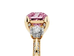 Fancy Pink Cushion Cut Diamond Three-Stone Ring Set in Yellow gold with Pavé Band and Smaller Side Stones
