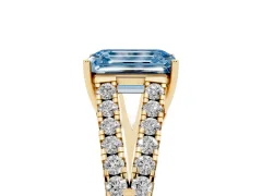 Fancy Blue Emerald Cut Diamond Split Shank Pavé Engagement Ring Set in Yellow gold with Prong-Held Center Stone