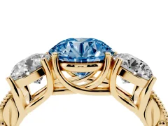 Fancy Blue Round Cut Diamond Three-Stone Engagement Ring Set in Yellow gold with Milgrain Pavé Band