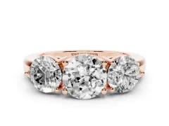 Round Cut Diamond Three-Stone Ring Set in Rose gold with Prong Setting and Plain Band