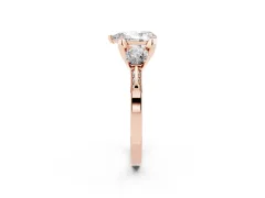 Pear Cut Diamond Three-Stone Ring Set in Rose gold with Pavé Band and Smaller Side Stones