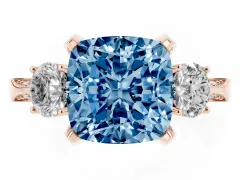 Fancy Blue Cushion Cut Diamond Three-Stone Ring Set in Rose gold with Pavé Band and Smaller Side Stones