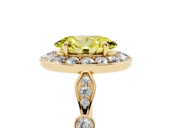 Fancy Yellow Oval Cut Diamond Halo Engagement Ring Set in Yellow gold with Twisted Band and Prong Setting