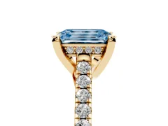 Fancy Blue Emerald Cut Diamond Solitaire Ring Set in Yellow gold with Brilliant Pavé Band and Prong Setting