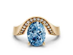 Fancy Blue Oval Cut Diamond Solitaire Engagement Ring Set in Yellow gold with Pavé Shoulders
