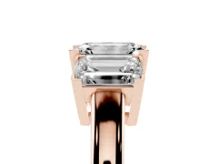 Emerald Cut Diamond Three-Stone Ring Set in Rose gold with Channel-Set Band and Prong Settings
