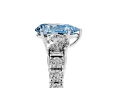 Fancy Blue Pear Cut Diamond Three-Stone Ring Set in Platinum with Round Side Stones and Delicate Pavé Band