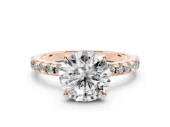 Round Cut Diamond Pavé Solitaire Ring Set in Rose gold with Round Band Accents and Prong Setting