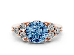 Fancy Blue Round Cut Diamond Solitaire Ring Set in Rose gold with Cluster Accents on Each Side