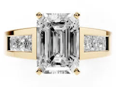Emerald Cut Diamond Solitaire Ring Set in Yellow gold with Channel-Set Accent Stones and Prong Setting