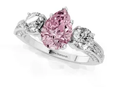 Fancy Pink Pear Cut Diamond Three-Stone Ring Set in White gold with Round Side Stones and Pavé Band