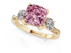 Fancy Pink Cushion Cut Diamond Three-Stone Ring Set in Yellow gold with Pavé Band and Smaller Side Stones