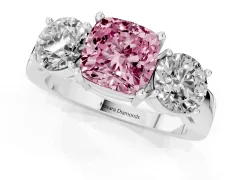 Fancy Pink Cushion Cut Diamond Three-Stone Ring Set in Platinum with Round Side Stones and Classic Band