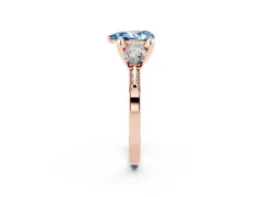 Fancy Blue Pear Cut Diamond Three-Stone Ring Set in Rose gold with Pavé Band and Smaller Side Stones