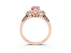 Fancy Pink Pear Cut Diamond Three-Stone Ring Set in Rose gold with Pavé Band and Smaller Side Stones