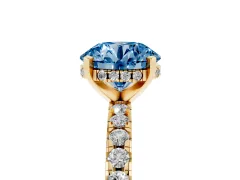 Fancy Blue Round Cut Diamond Pavé Solitaire Ring Set in Yellow gold with Round Band Accents and Prong Setting