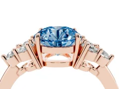 Fancy Blue Round Cut Diamond Solitaire Ring Set in Rose gold with Cluster Accents on Each Side