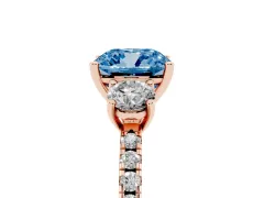 Fancy Blue Cushion Cut Diamond Three-Stone Ring Set in Rose gold with Pavé Band and Graduated Sides