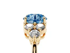 Fancy Blue Round Cut Diamond Solitaire Ring Set in Yellow gold with Cluster Accents on Each Side