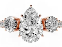 Pear Cut Diamond Three-Stone Ring Set in Rose gold with Round Side Stones and Delicate Pavé Band