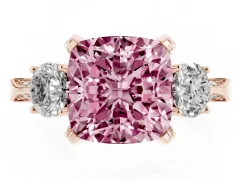 Fancy Pink Cushion Cut Diamond Three-Stone Ring Set in Rose gold with Pavé Band and Smaller Side Stones