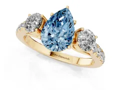 Fancy Blue Pear Cut Diamond Three-Stone Ring Set in Yellow gold with Round Side Stones and Delicate Pavé Band