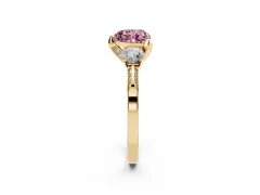 Fancy Pink Heart Cut Diamond Three-Stone Ring Set in Yellow gold with Pavé Band and Smaller Side Stones