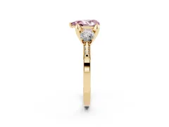 Fancy Pink Pear Cut Diamond Three-Stone Ring Set in Yellow gold with Pavé Band and Smaller Side Stones