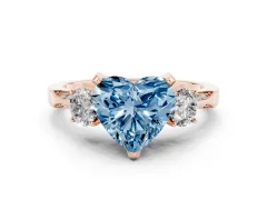 Fancy Blue Heart Cut Diamond Three-Stone Ring Set in Rose gold with Pavé Band and Smaller Side Stones