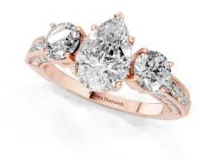 Pear Cut Diamond Three-Stone Ring Set in Rose gold with Round Side Stones and Pavé Band