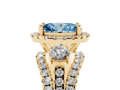 Fancy Blue Oval Cut Diamond Halo Split Shank Ring Set in Yellow gold with Round Accent Stones and Prong Setting
