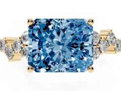 Fancy Blue Radiant Cut Diamond Ring Set in Yellow gold with Scattered Round Accents