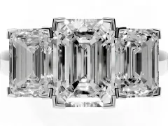 Emerald Cut Diamond Three-Stone Ring Set in Platinum with Channel-Set Band and Prong Settings