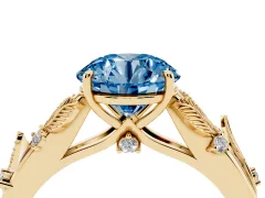 Fancy Blue Round Cut Diamond Solitaire Ring Set in Yellow gold with Leaf Motif Band