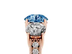 Fancy Blue Round Cut Diamond Three-Stone Engagement Ring Set in Rose gold with Milgrain Pavé Band