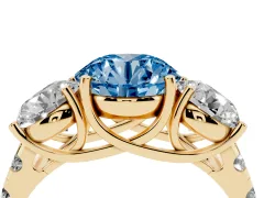 Fancy Blue Round Cut Diamond Three-Stone Ring Set in Yellow gold with Pavé Band