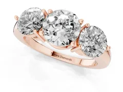 Round Cut Diamond Three-Stone Ring Set in Rose gold with Prong Setting and Plain Band