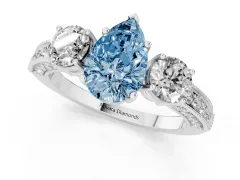 Fancy Blue Pear Cut Diamond Three-Stone Ring Set in White gold with Round Side Stones and Pavé Band
