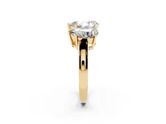 Pear Cut Diamond Three-Stone Ring Set in Yellow gold with Channel-Set Band and Prong Settings