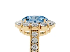 Fancy Blue Oval Cut Diamond Halo Pavé Engagement Ring Set in Yellow gold with Milgrain Detailing