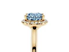 Fancy Blue Oval Cut Diamond Halo Engagement Ring Set in Yellow gold with Pavé Band and Rising Shoulders