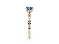 Fancy Blue Cushion Cut Diamond Solitaire Engagement Ring Set in Yellow gold with Round Pavé Band and Prong Setting