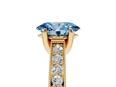 Fancy Blue Oval Cut Diamond Solitaire Ring Set in Yellow gold with Milgrain-Edged Pavé Band and Prong Setting