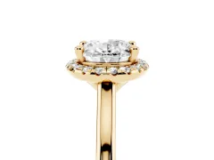 Oval Cut Diamond Halo Engagement Ring Set in Yellow gold with Pavé Band and Rising Shoulders