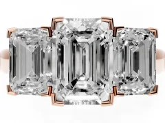 Emerald Cut Diamond Three-Stone Ring Set in Rose gold with Channel-Set Band and Prong Settings