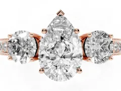 Pear Cut Diamond Three-Stone Ring Set in Rose gold with Round Side Stones and Pavé Band