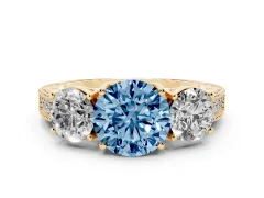 Fancy Blue Round Cut Diamond Three-Stone Engagement Ring Set in Yellow gold with Milgrain Pavé Band