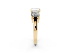 Princess Cut Diamond Three-Stone Ring Set in Yellow gold with Channel-Set Band and Prong Settings