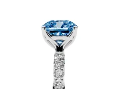 Fancy Blue Cushion Cut Diamond Solitaire Engagement Ring Set in Platinum with Round Pavé Band and Prong Setting